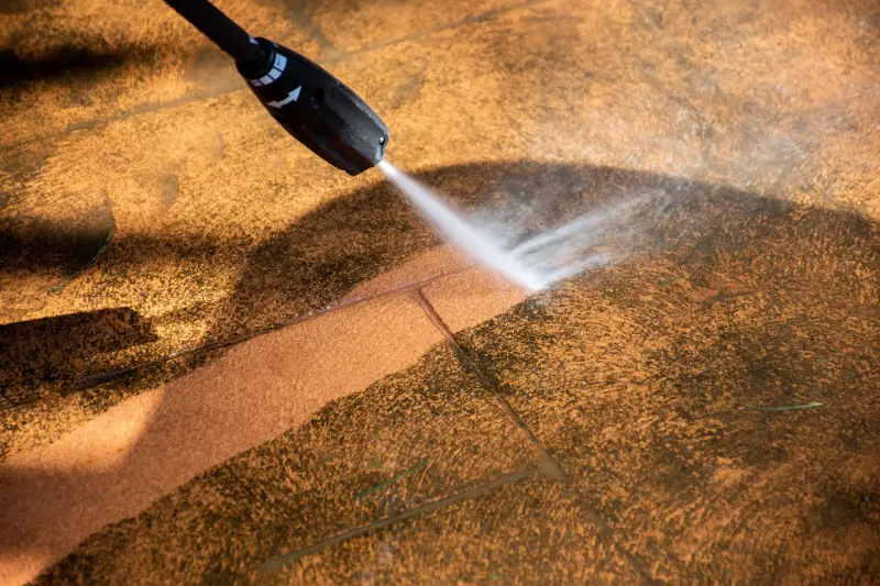washing the backyard tiles with high pressure cleaning